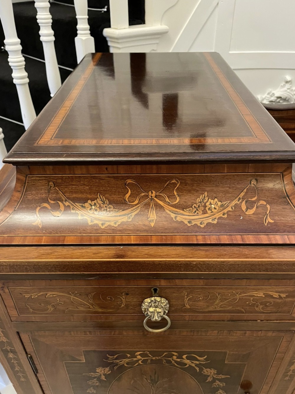A nineteenth-century mahogany sideboard with detailed floral marquetry inlays, a stepped pedestal top, multiple drawers with brass lion mask ring handles, and tapered square legs. View IV