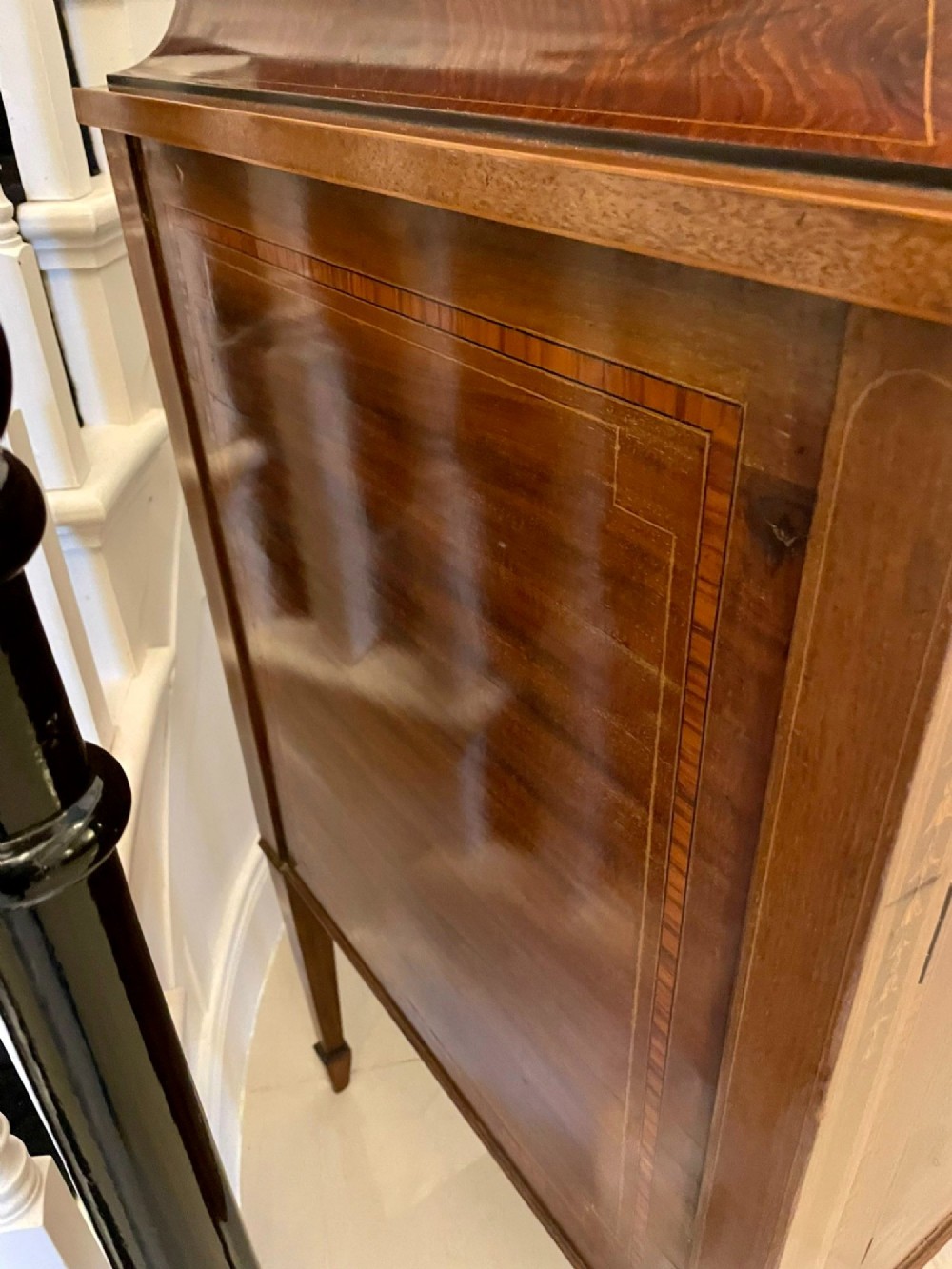 A nineteenth-century mahogany sideboard with detailed floral marquetry inlays, a stepped pedestal top, multiple drawers with brass lion mask ring handles, and tapered square legs. View VI