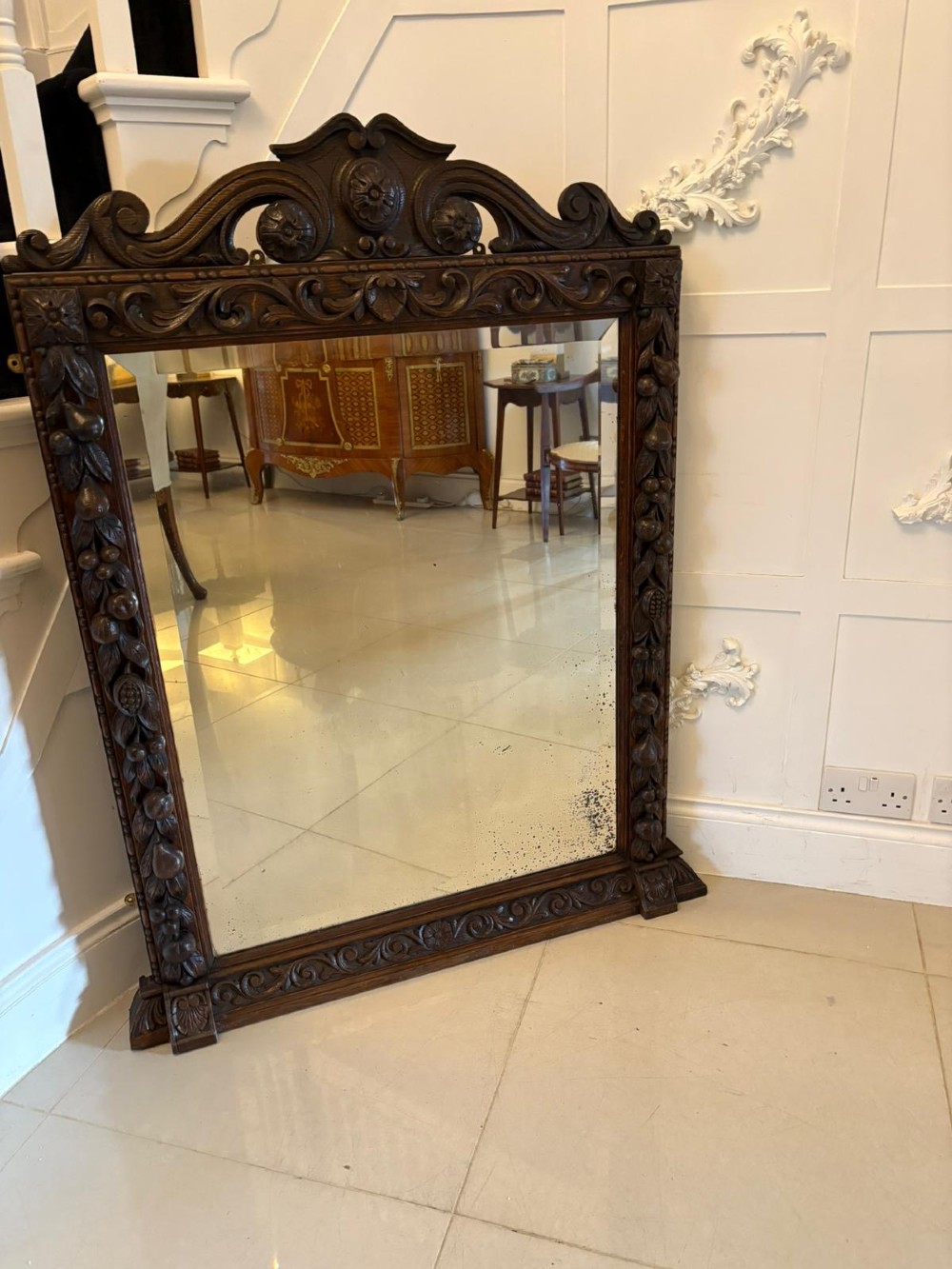 A 19th-century Victorian dark oak wall mirror featuring carved fruit and leaf motifs along the frame and a curved cresting pediment. View VII