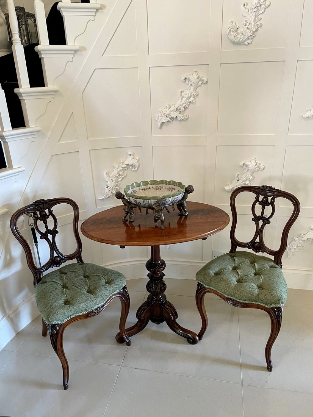 A set of four Victorian French carved walnut side chairs featuring openwork backrests and button-upholstered sage green fabric seats on cabriole legs. View III