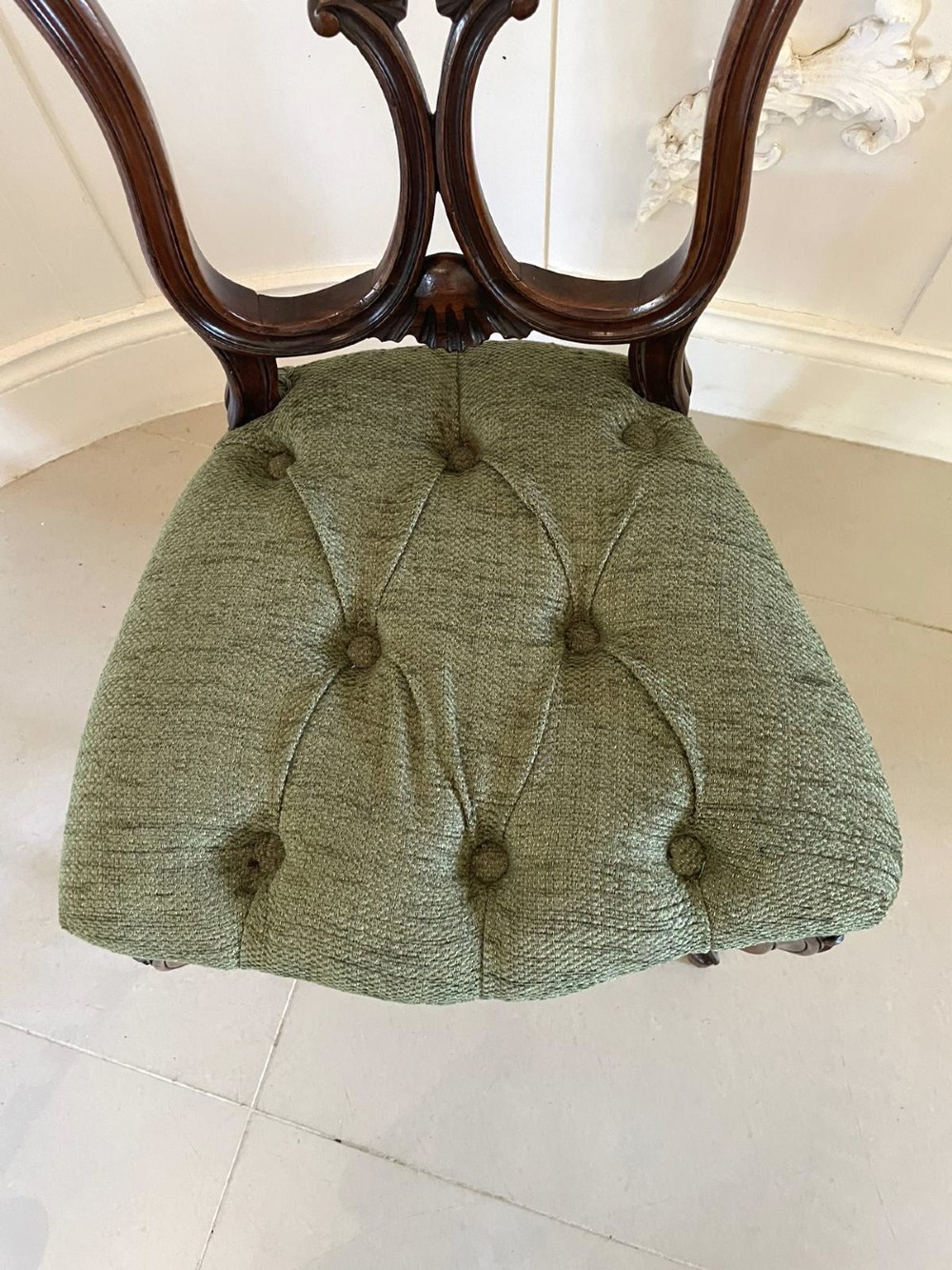 A set of four Victorian French carved walnut side chairs featuring openwork backrests and button-upholstered sage green fabric seats on cabriole legs. View IV