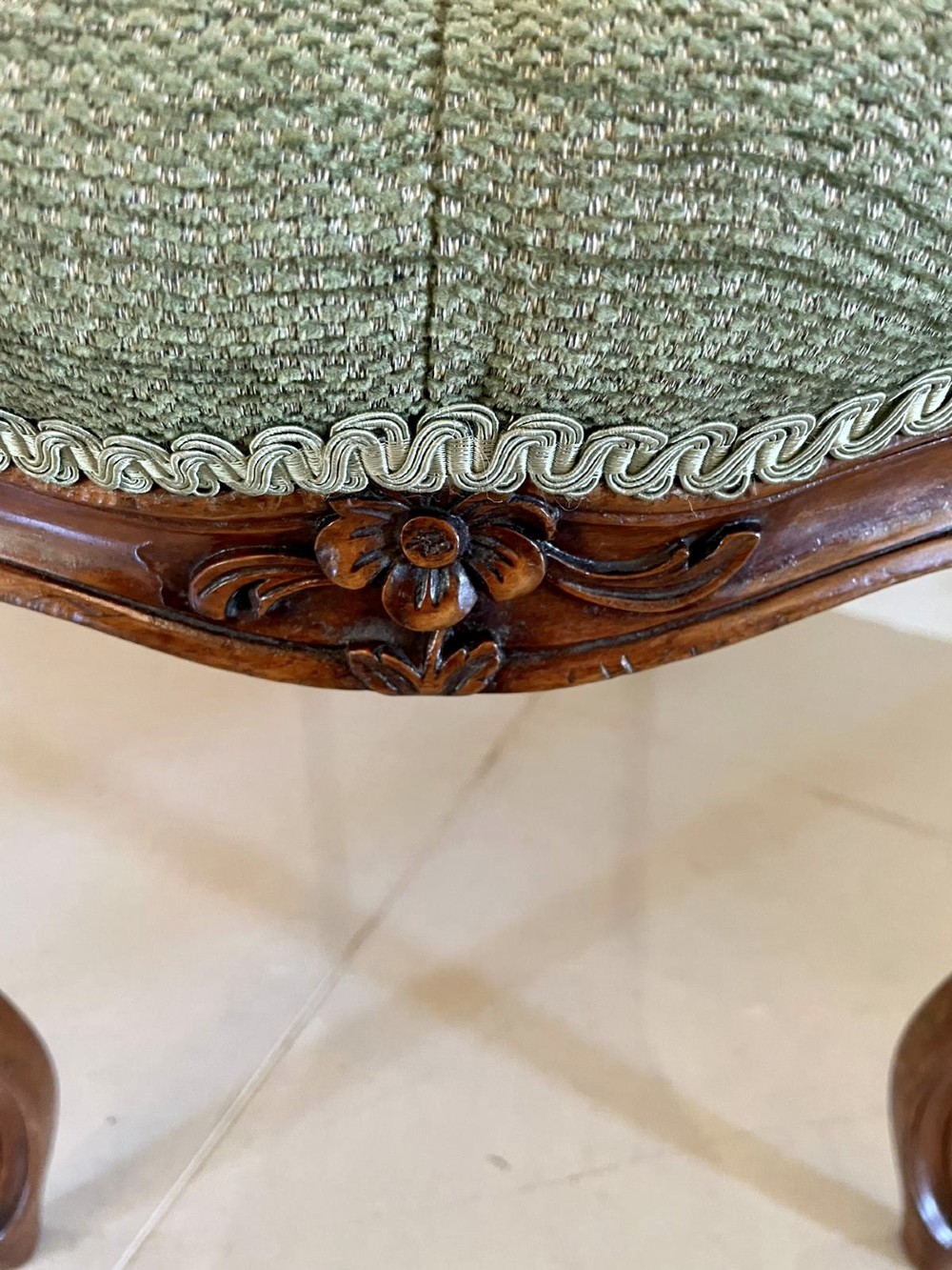 A set of four Victorian French carved walnut side chairs featuring openwork backrests and button-upholstered sage green fabric seats on cabriole legs. View VIII