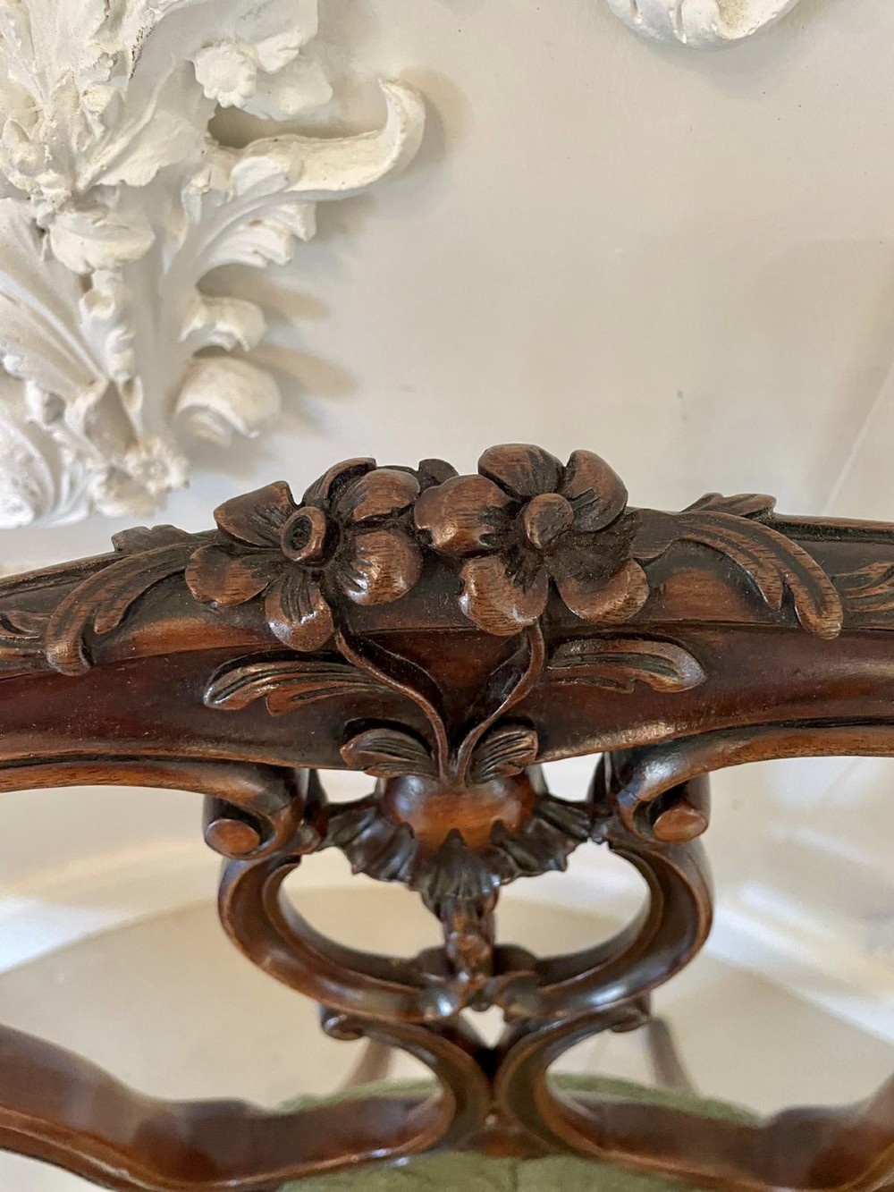 A set of four Victorian French carved walnut side chairs featuring openwork backrests and button-upholstered sage green fabric seats on cabriole legs. View IX