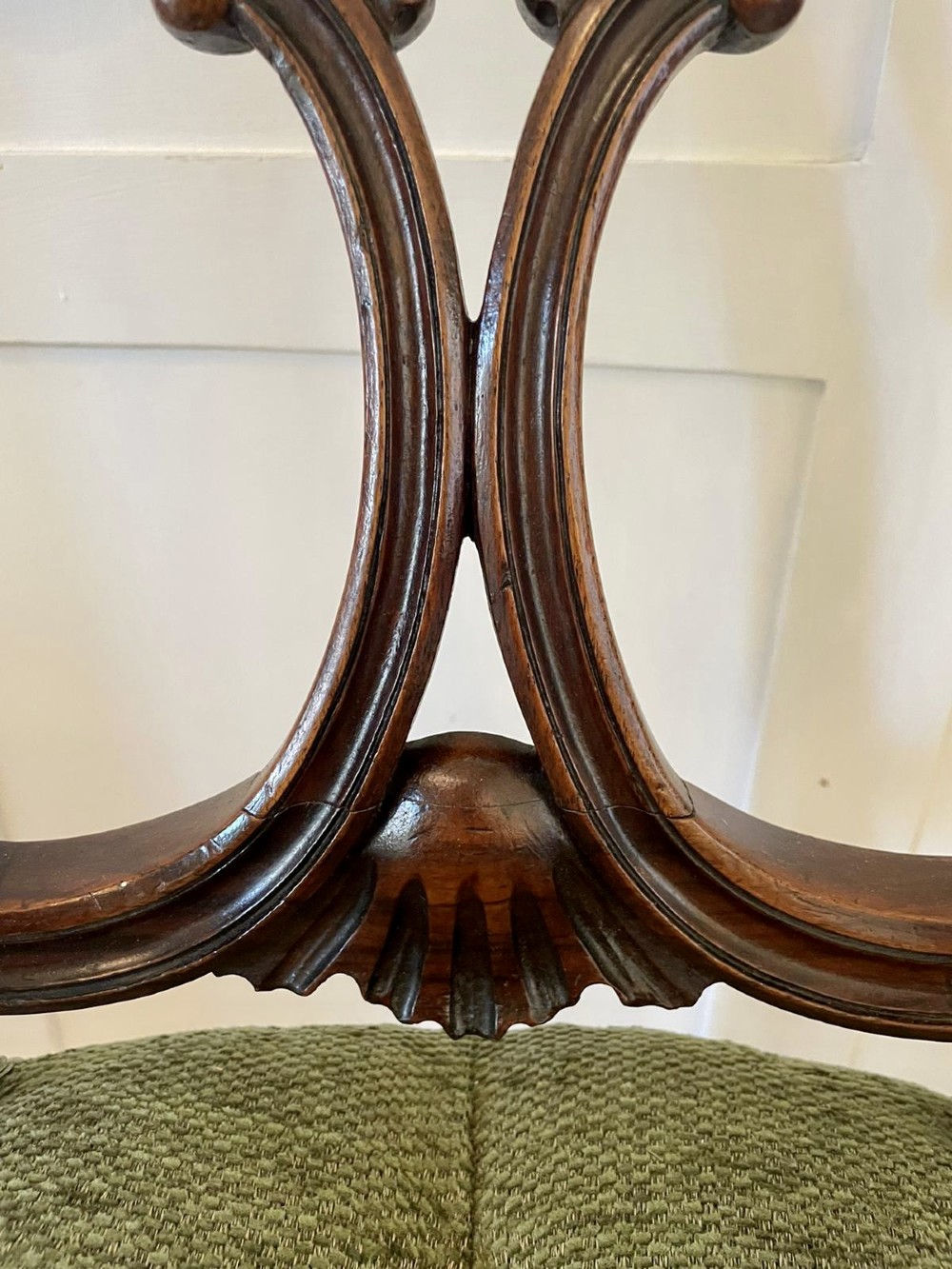 A set of four Victorian French carved walnut side chairs featuring openwork backrests and button-upholstered sage green fabric seats on cabriole legs. View XII