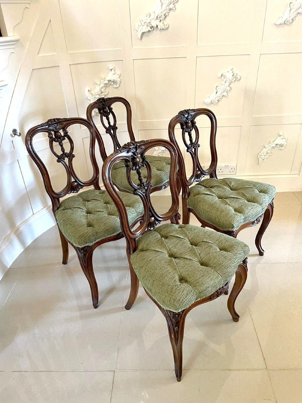A set of four Victorian French carved walnut side chairs featuring openwork backrests and button-upholstered sage green fabric seats on cabriole legs. View XIV
