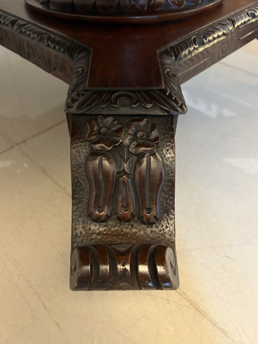 An antique Victorian octagonal dark oak centre table featuring heavily carved foliate designs along the apron and a sturdy central base. View III