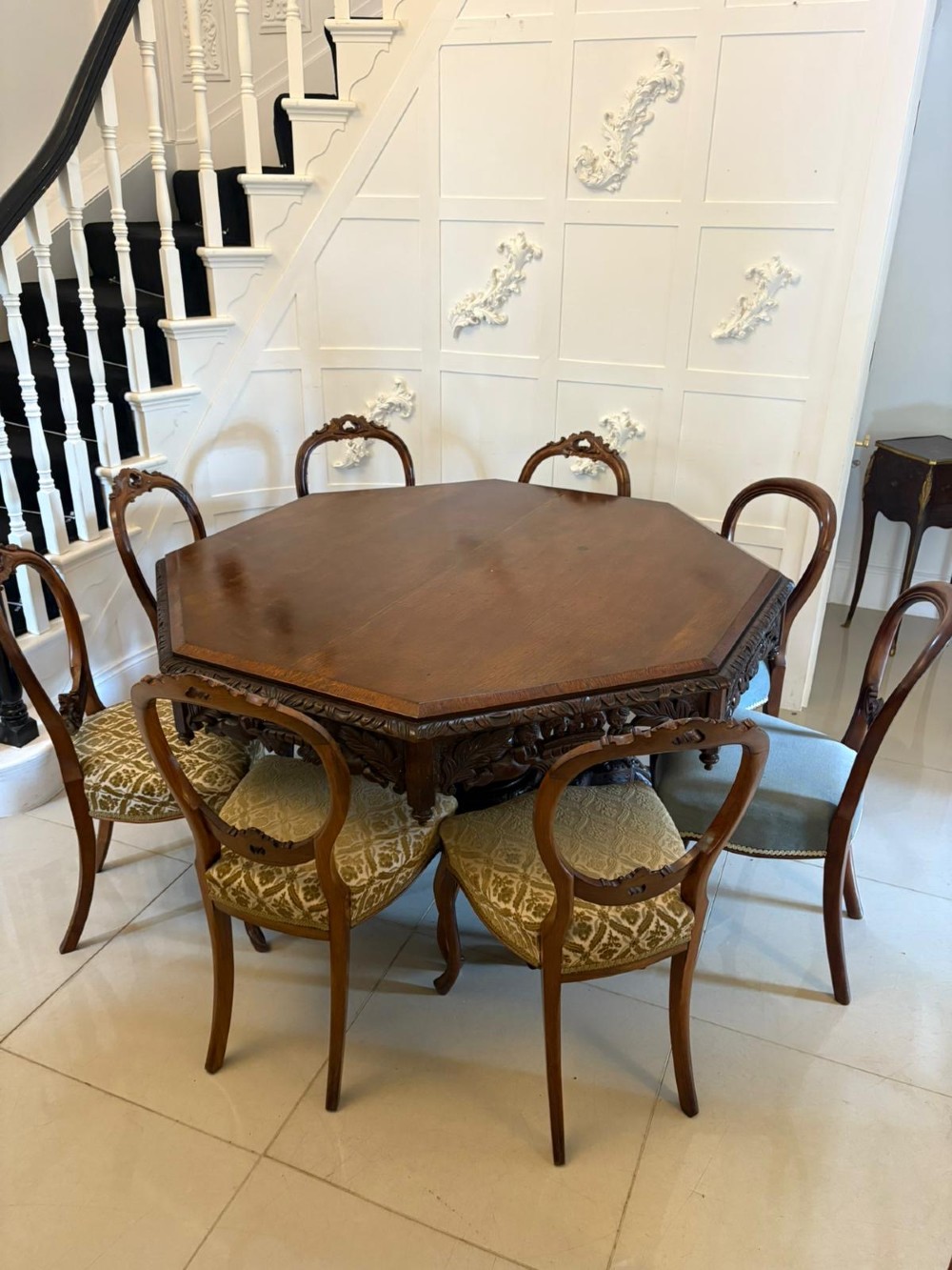 An antique Victorian octagonal dark oak centre table featuring heavily carved foliate designs along the apron and a sturdy central base. View IV