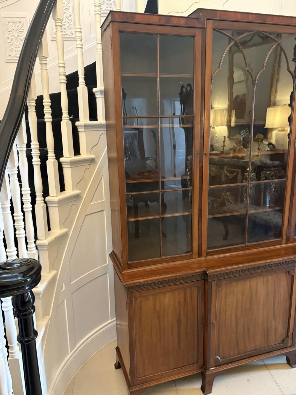 An antique Edwardian mahogany breakfront bookcase featuring three glazed upper doors with astragal moulding above three solid wooden cabinet doors. View VII
