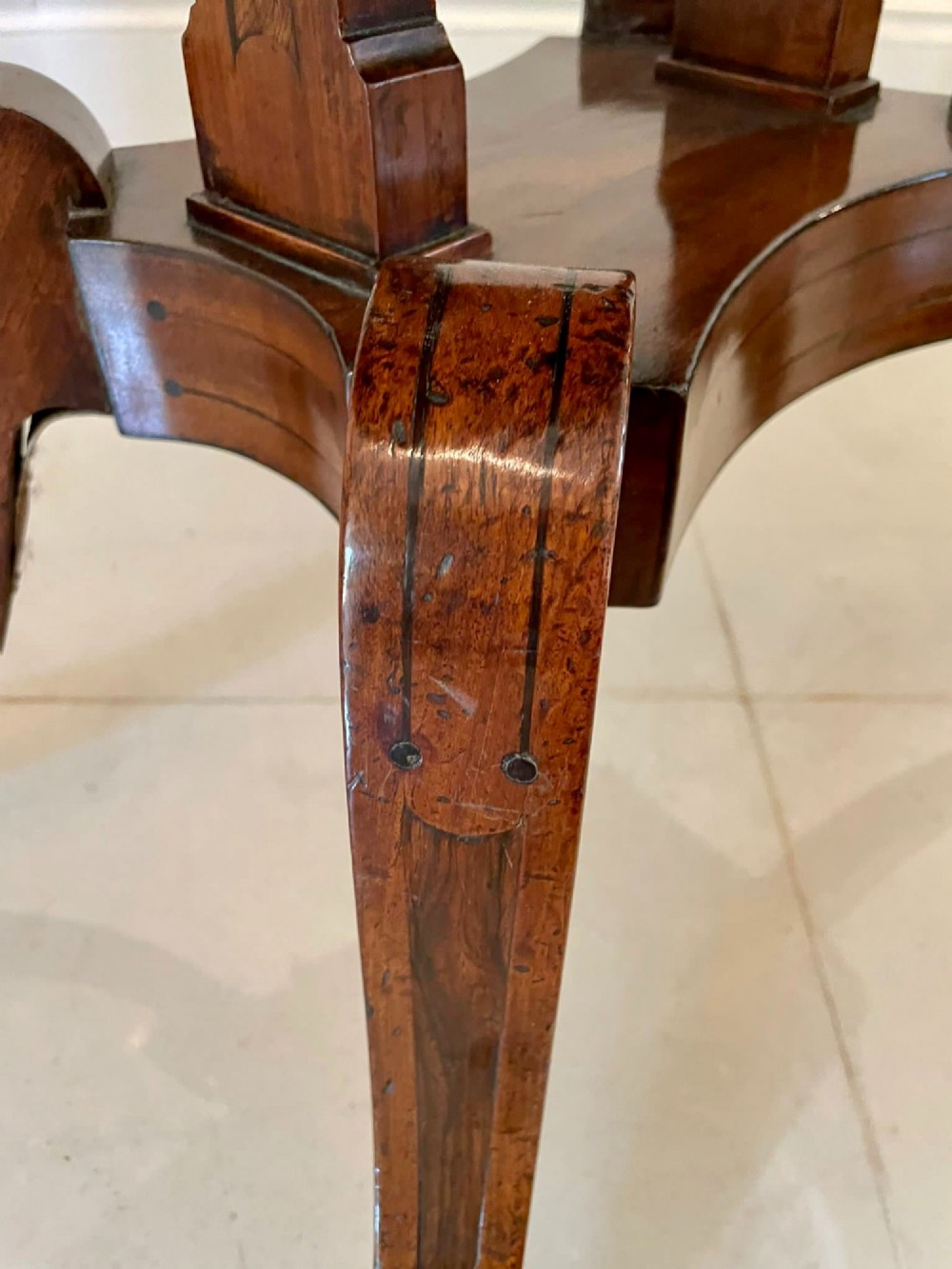 A Regency mahogany fold-over card table featuring an inlaid apron, central pedestal support, and four sabre legs with brass lion paw feet and castors. View VII