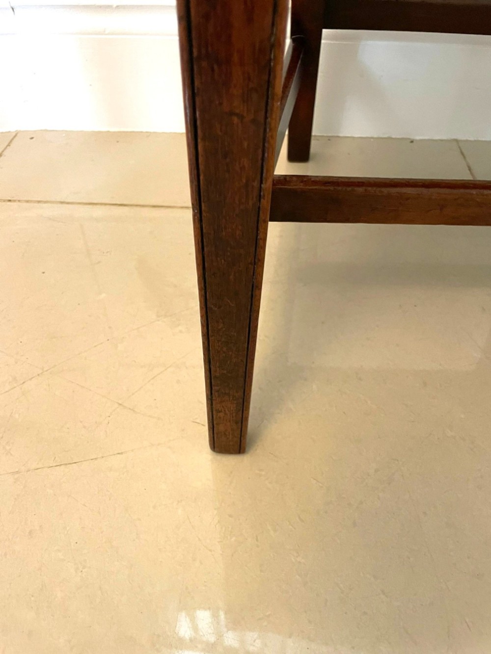 A set of eight George III mahogany dining chairs featuring carved vertical back splats and beige plaid upholstered drop-in seats, including six side chairs and two armchairs. View II