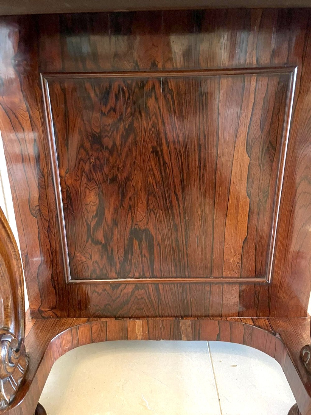 A Victorian rosewood Davenport desk featuring a sloped dark green leather writing surface, decorative brass gallery rail, carved cabriole front supports, and side drawers. View IV