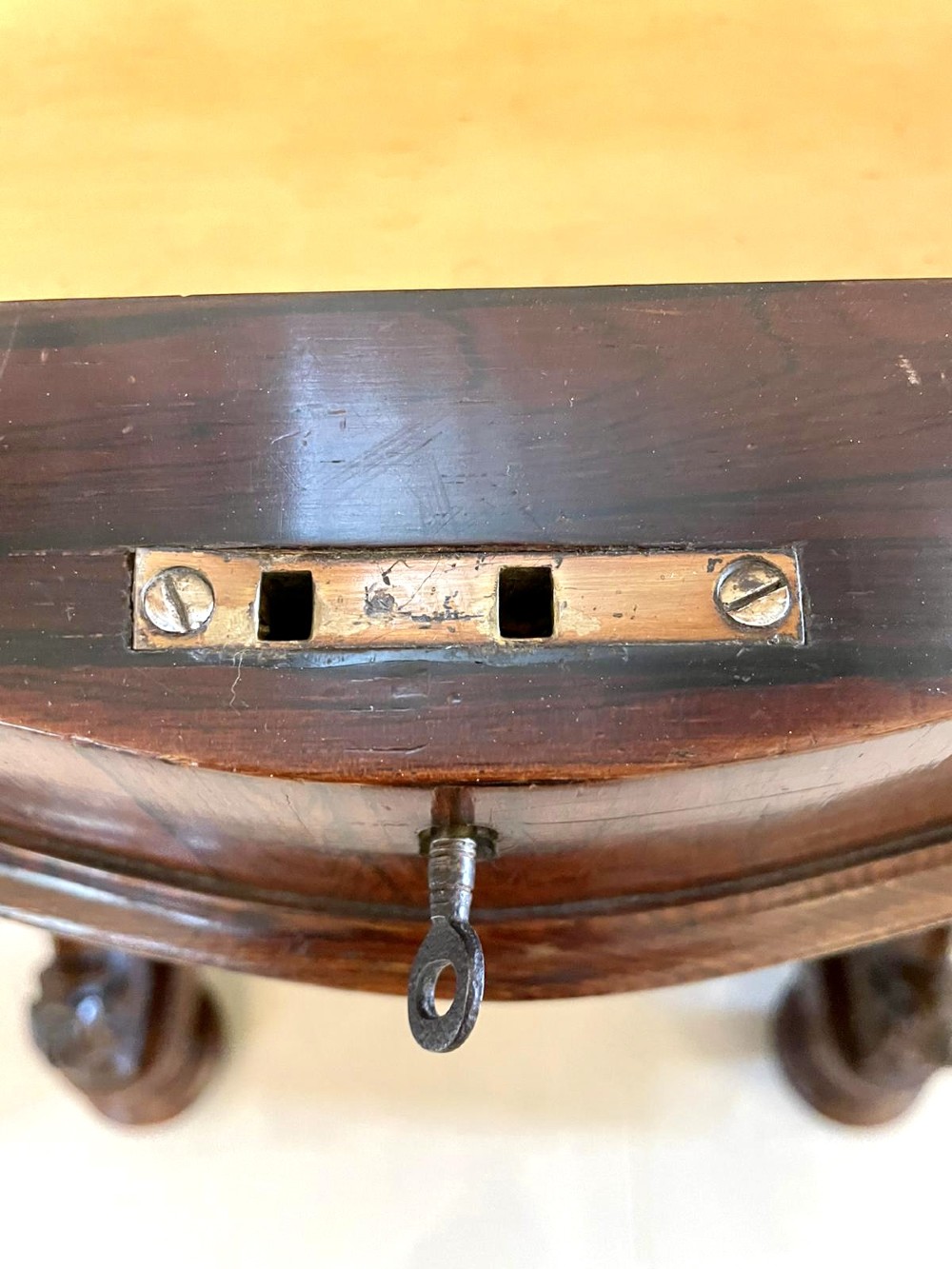 A Victorian rosewood Davenport desk featuring a sloped dark green leather writing surface, decorative brass gallery rail, carved cabriole front supports, and side drawers. View VI