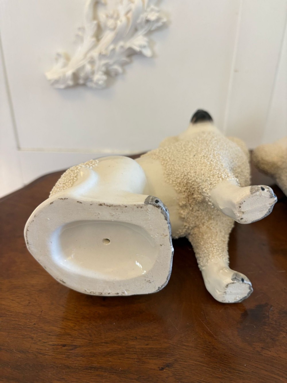 A matching pair of Victorian cream earthenware Staffordshire poodle figurines sitting upright with hand-applied textured fur and gilded collar details. View IV