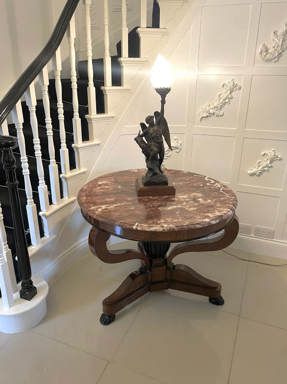 A circular antique French centre table featuring a polished red-and-white variegated marble top on a mahogany apron with curved legs and carved paw feet. View II
