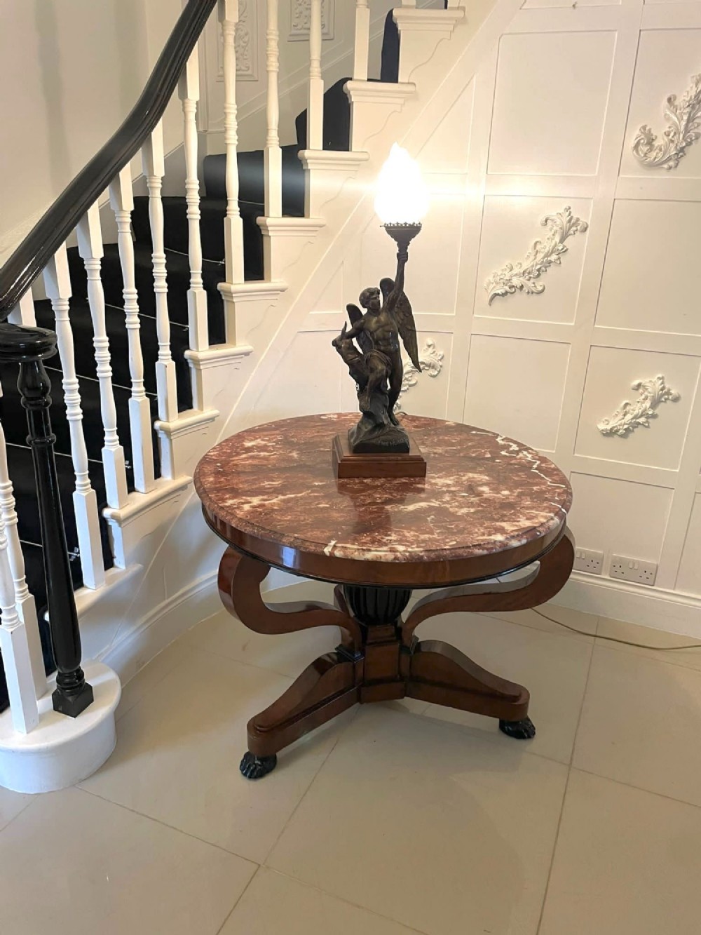 A circular antique French centre table featuring a polished red-and-white variegated marble top on a mahogany apron with curved legs and carved paw feet. View IV