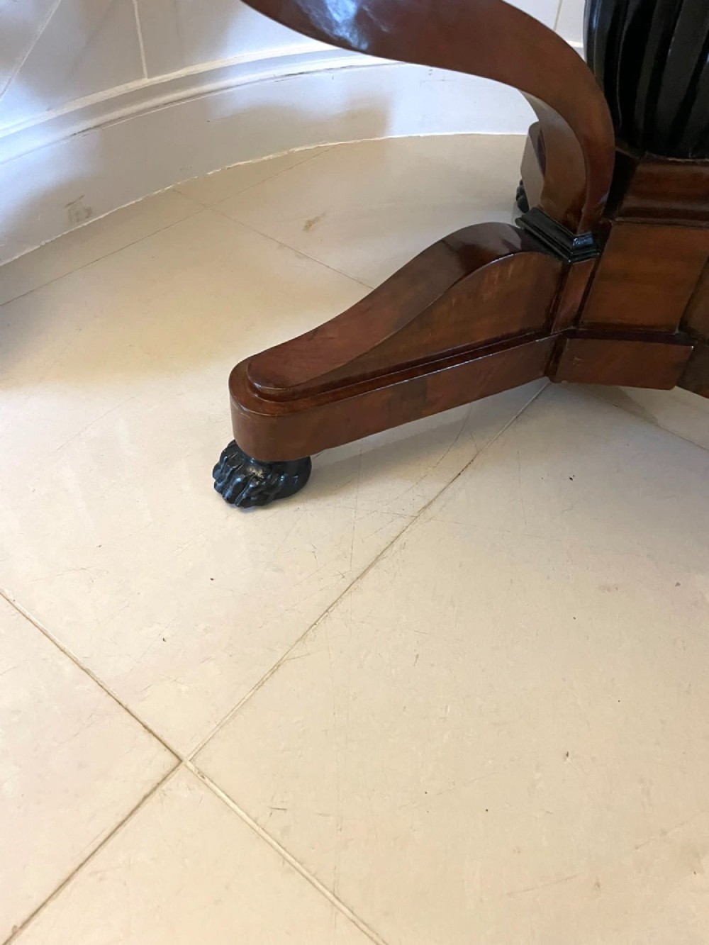 A circular antique French centre table featuring a polished red-and-white variegated marble top on a mahogany apron with curved legs and carved paw feet. View VI