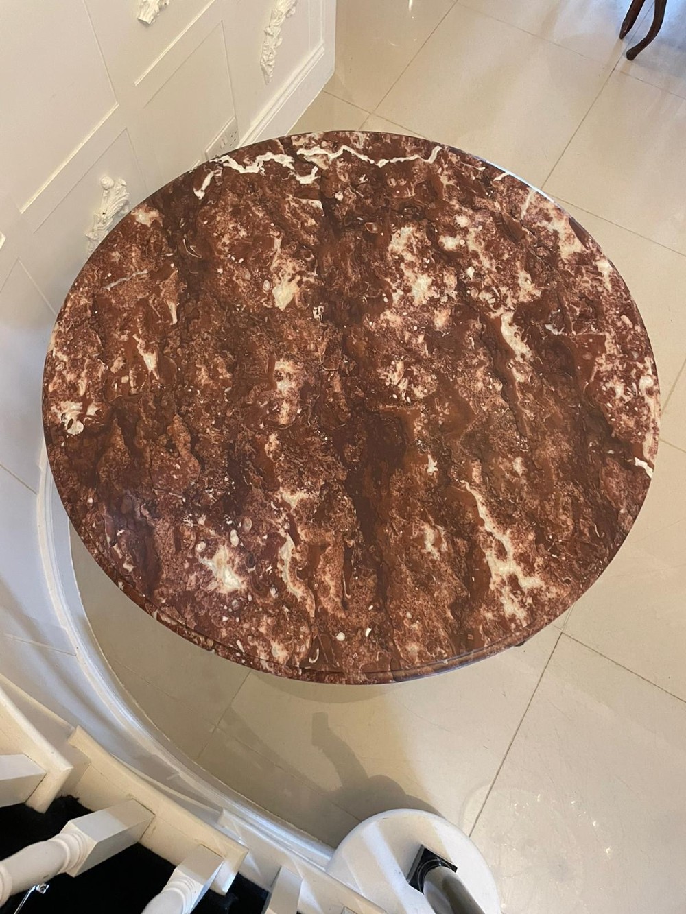 A circular antique French centre table featuring a polished red-and-white variegated marble top on a mahogany apron with curved legs and carved paw feet. View IX
