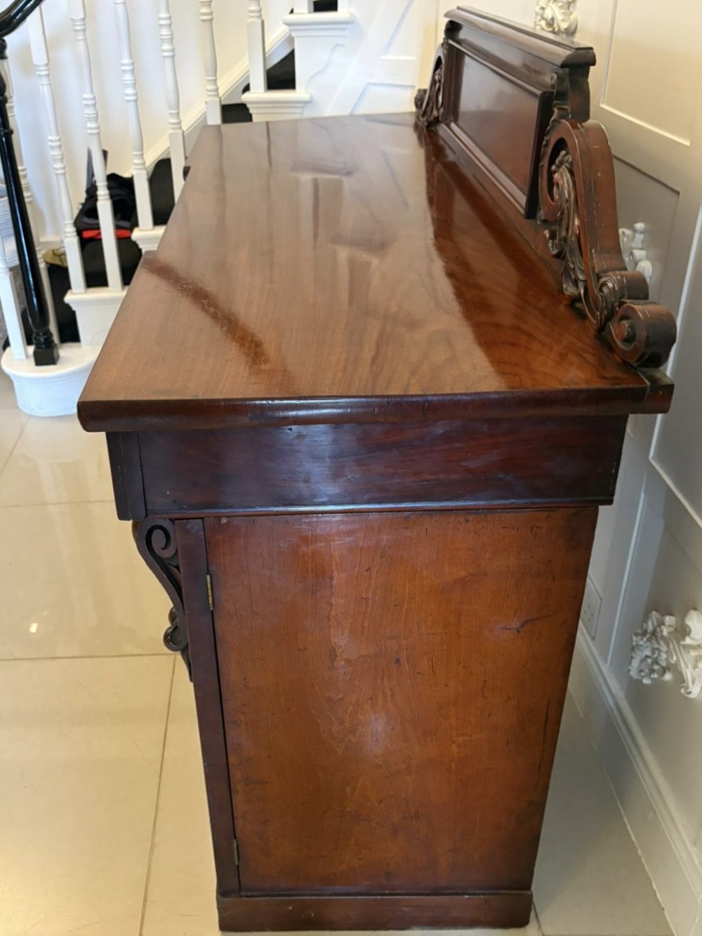 A Victorian mahogany pedestal sideboard featuring a raised backboard with carved scrollwork and two flanking pedestal cupboards. View IV
