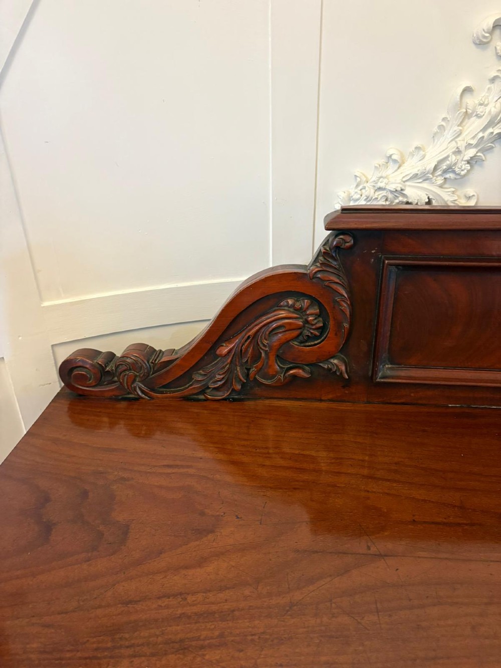 A Victorian mahogany pedestal sideboard featuring a raised backboard with carved scrollwork and two flanking pedestal cupboards. View IX