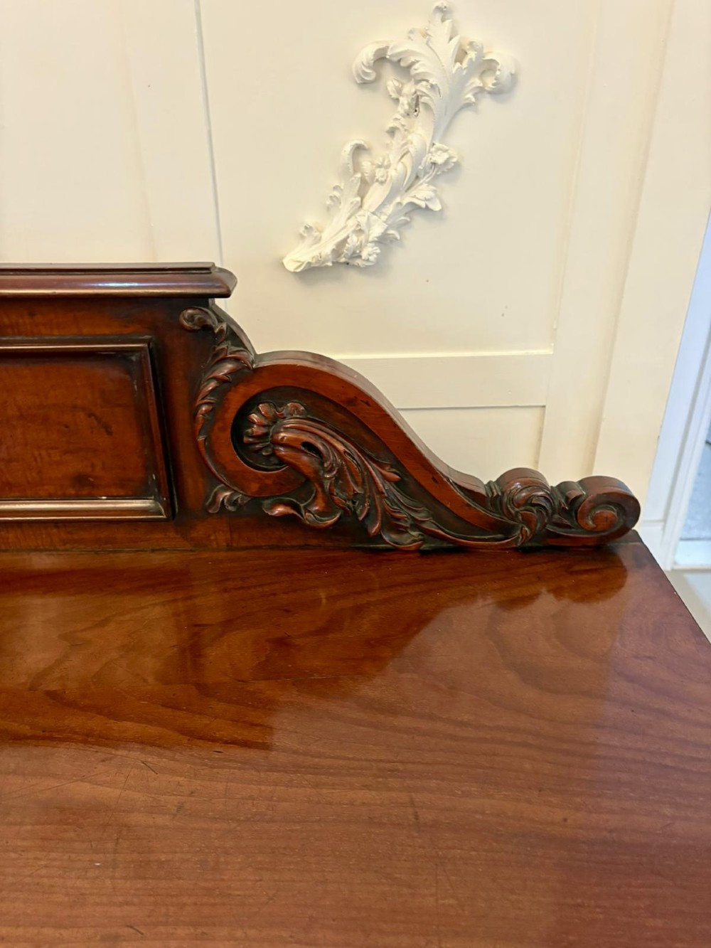 A Victorian mahogany pedestal sideboard featuring a raised backboard with carved scrollwork and two flanking pedestal cupboards. View XI