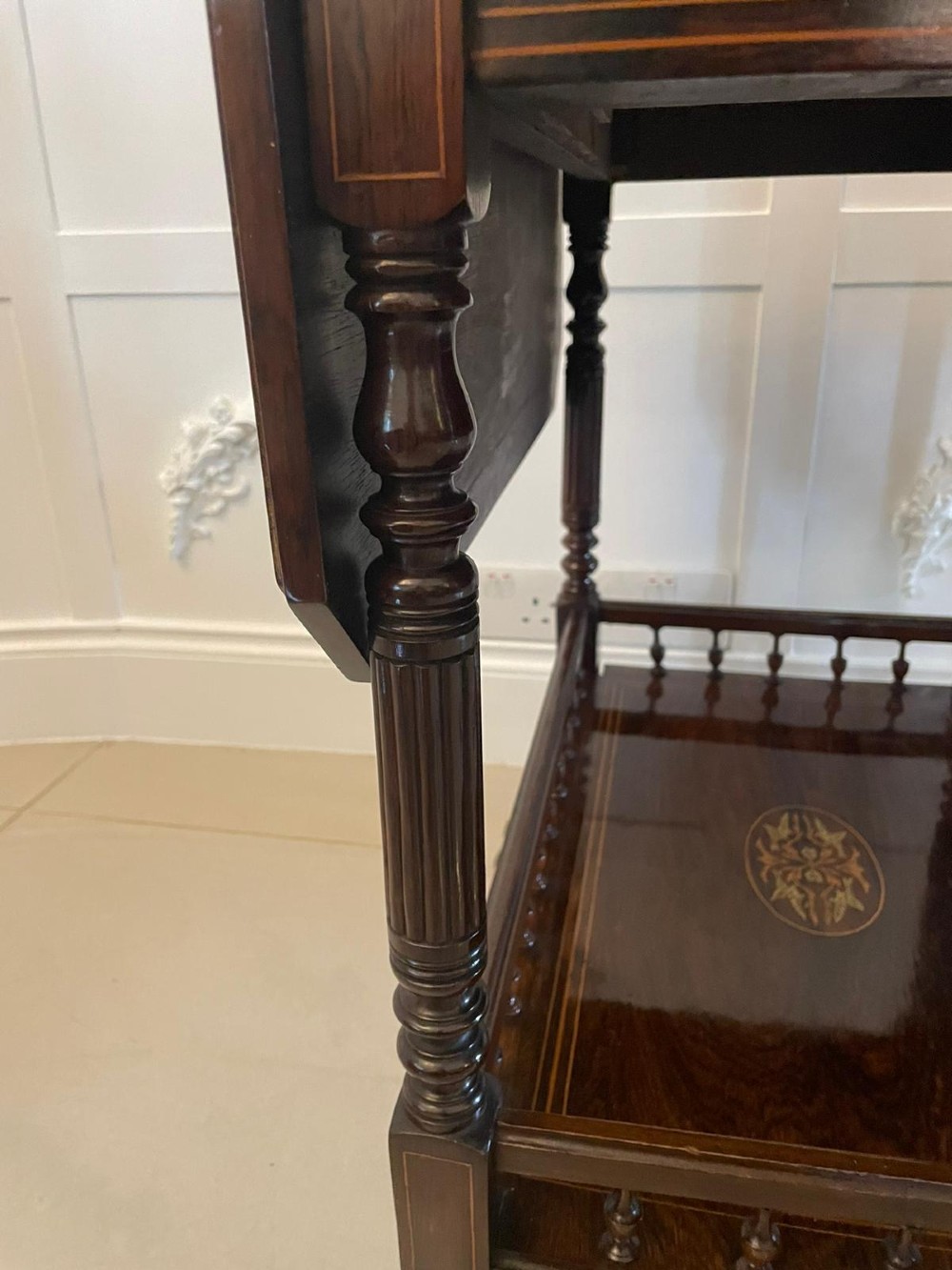A Victorian rosewood drop-leaf centre table featuring floral marquetry inlay, turned legs on brass castors, and a lower tiered shelf with a spindle gallery. View II