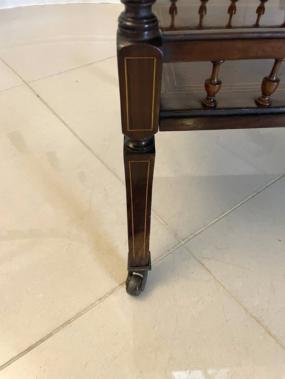 A Victorian rosewood drop-leaf centre table featuring floral marquetry inlay, turned legs on brass castors, and a lower tiered shelf with a spindle gallery. View VII