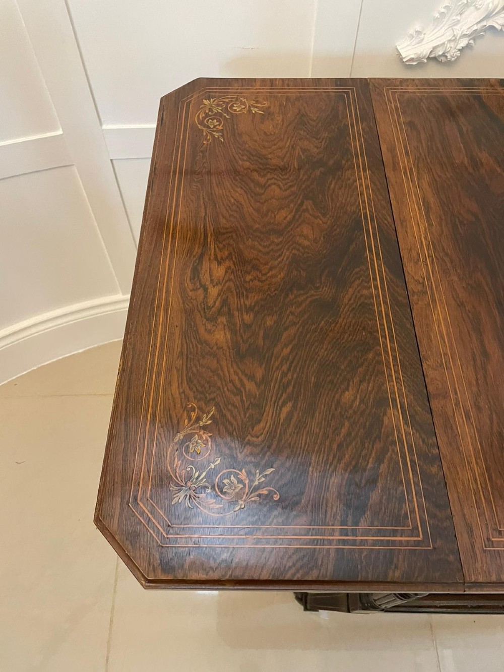 A Victorian rosewood drop-leaf centre table featuring floral marquetry inlay, turned legs on brass castors, and a lower tiered shelf with a spindle gallery. View XI