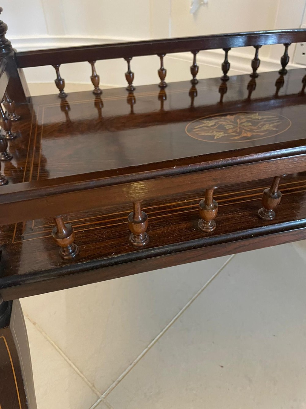A Victorian rosewood drop-leaf centre table featuring floral marquetry inlay, turned legs on brass castors, and a lower tiered shelf with a spindle gallery. View XII