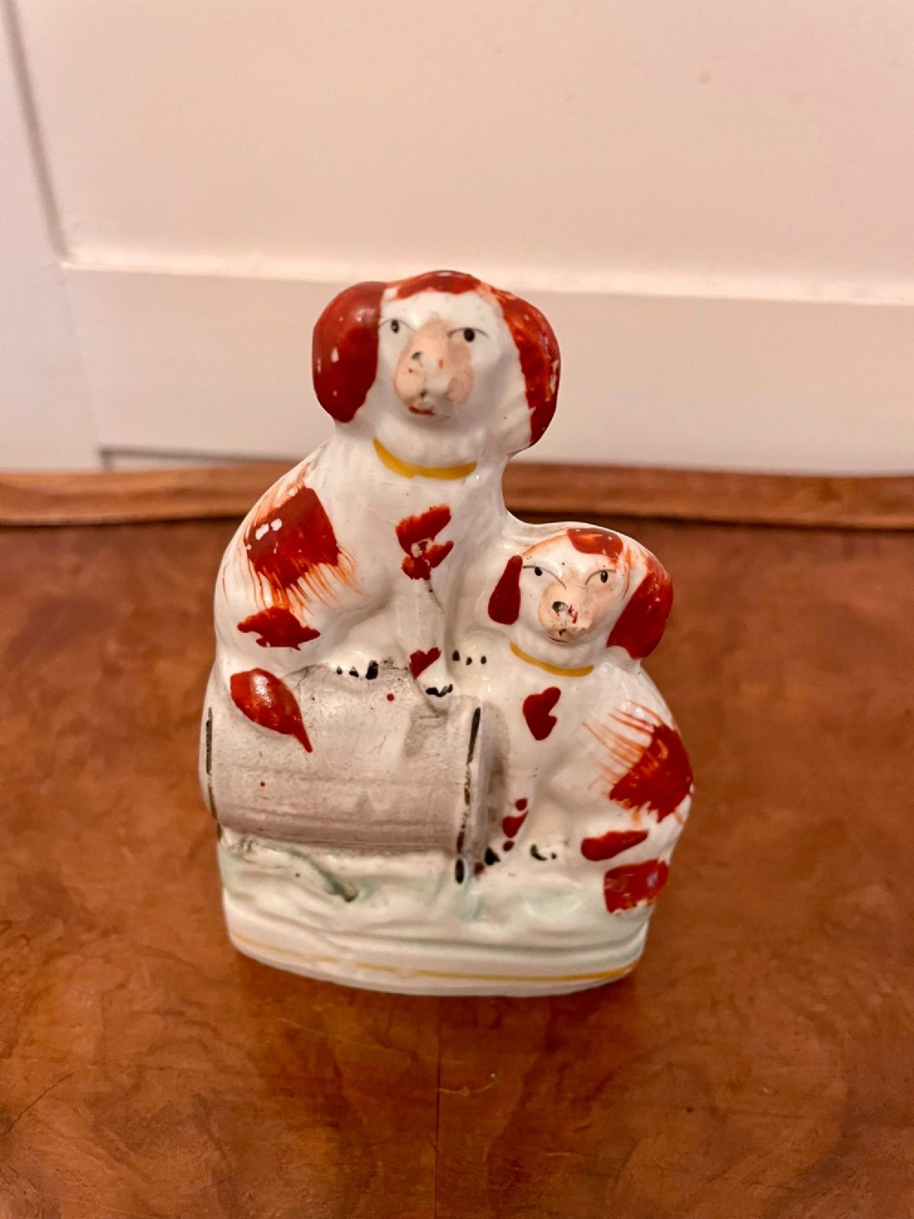 A collection of six antique Victorian earthenware Staffordshire dog figures with hand-painted rust red, black, and polychrome detailing. View V