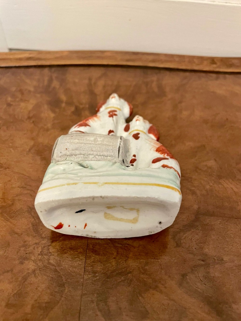 A collection of six antique Victorian earthenware Staffordshire dog figures with hand-painted rust red, black, and polychrome detailing. View IX