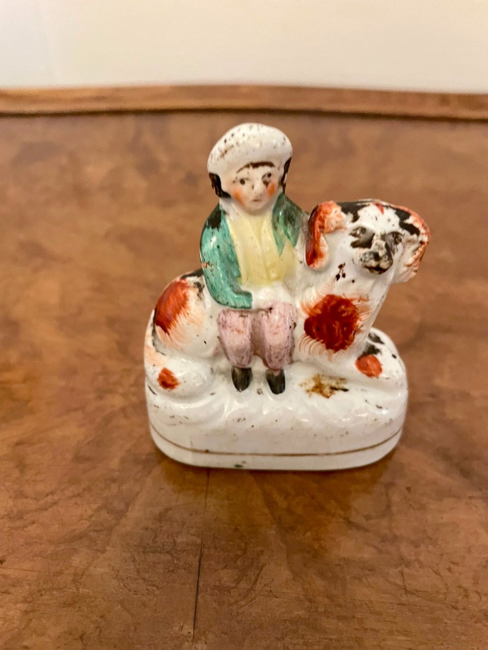 A collection of six antique Victorian earthenware Staffordshire dog figures with hand-painted rust red, black, and polychrome detailing. View XI