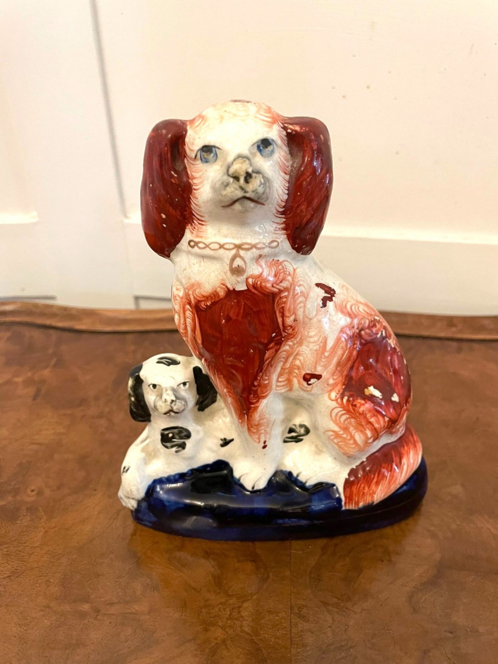 A collection of six antique Victorian earthenware Staffordshire dog figures with hand-painted rust red, black, and polychrome detailing. View XV