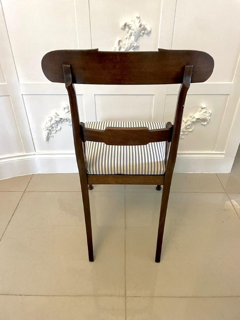 A set of four antique mahogany dining chairs featuring carved scroll top rails, turned front legs, and blue and white striped upholstered seats. View IX