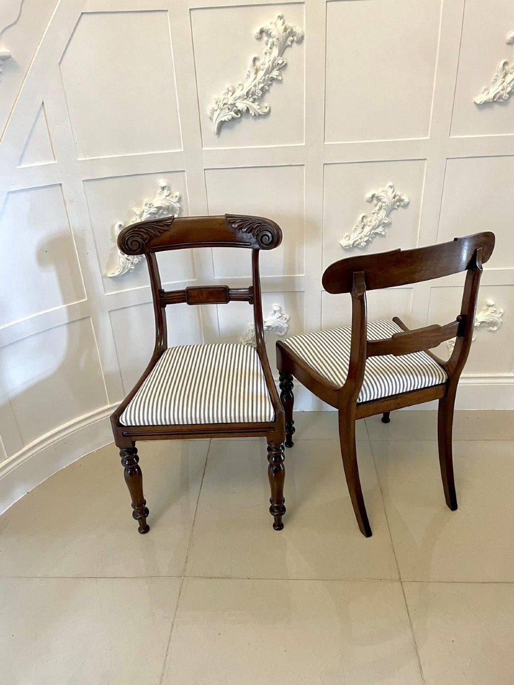 A set of four antique mahogany dining chairs featuring carved scroll top rails, turned front legs, and blue and white striped upholstered seats. View XI