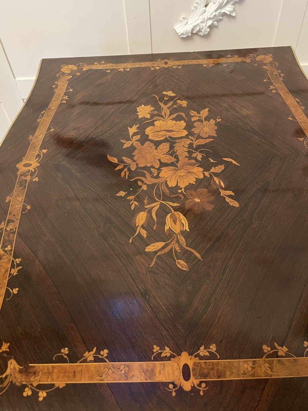 A French Louis XV style rosewood centre table featuring floral marquetry inlay, sweeping cabriole legs, and ornate gilt bronze mounts. View II