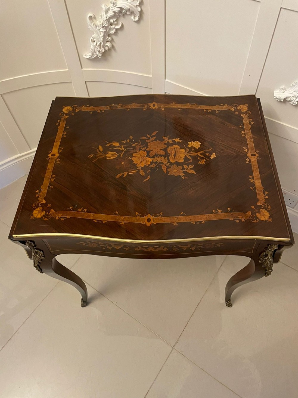 A French Louis XV style rosewood centre table featuring floral marquetry inlay, sweeping cabriole legs, and ornate gilt bronze mounts. View IV