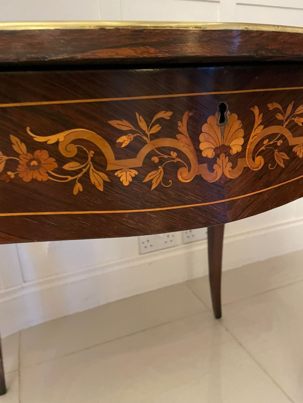 A French Louis XV style rosewood centre table featuring floral marquetry inlay, sweeping cabriole legs, and ornate gilt bronze mounts. View V