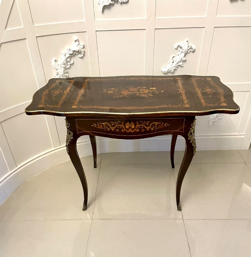 A French Louis XV style rosewood centre table featuring floral marquetry inlay, sweeping cabriole legs, and ornate gilt bronze mounts. View VII