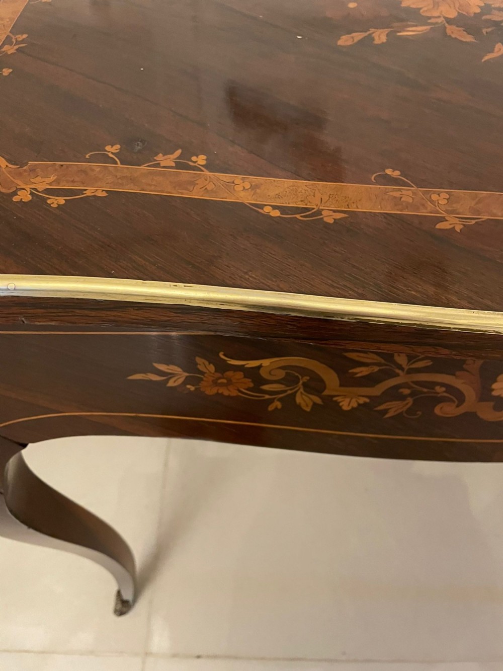 A French Louis XV style rosewood centre table featuring floral marquetry inlay, sweeping cabriole legs, and ornate gilt bronze mounts. View VIII