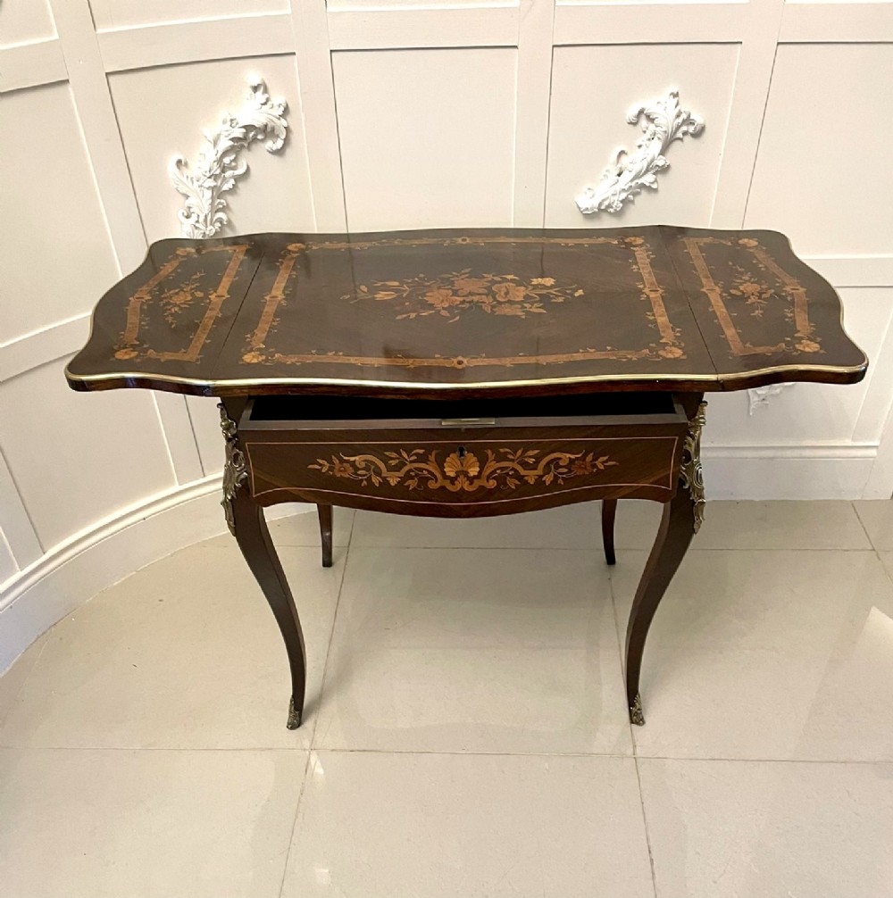 A French Louis XV style rosewood centre table featuring floral marquetry inlay, sweeping cabriole legs, and ornate gilt bronze mounts. View IX