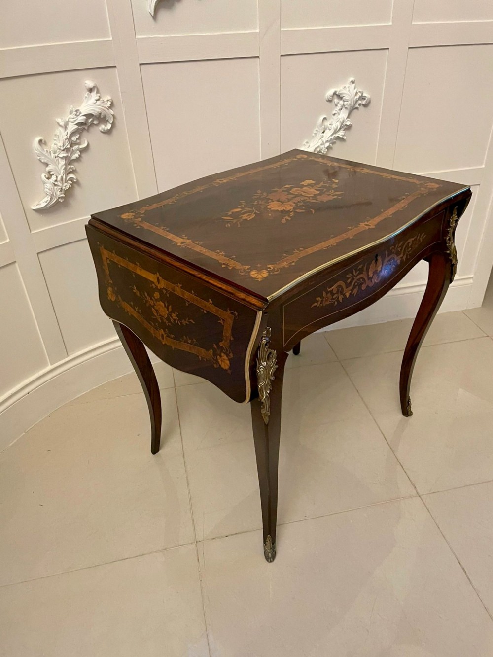 A French Louis XV style rosewood centre table featuring floral marquetry inlay, sweeping cabriole legs, and ornate gilt bronze mounts. View XI