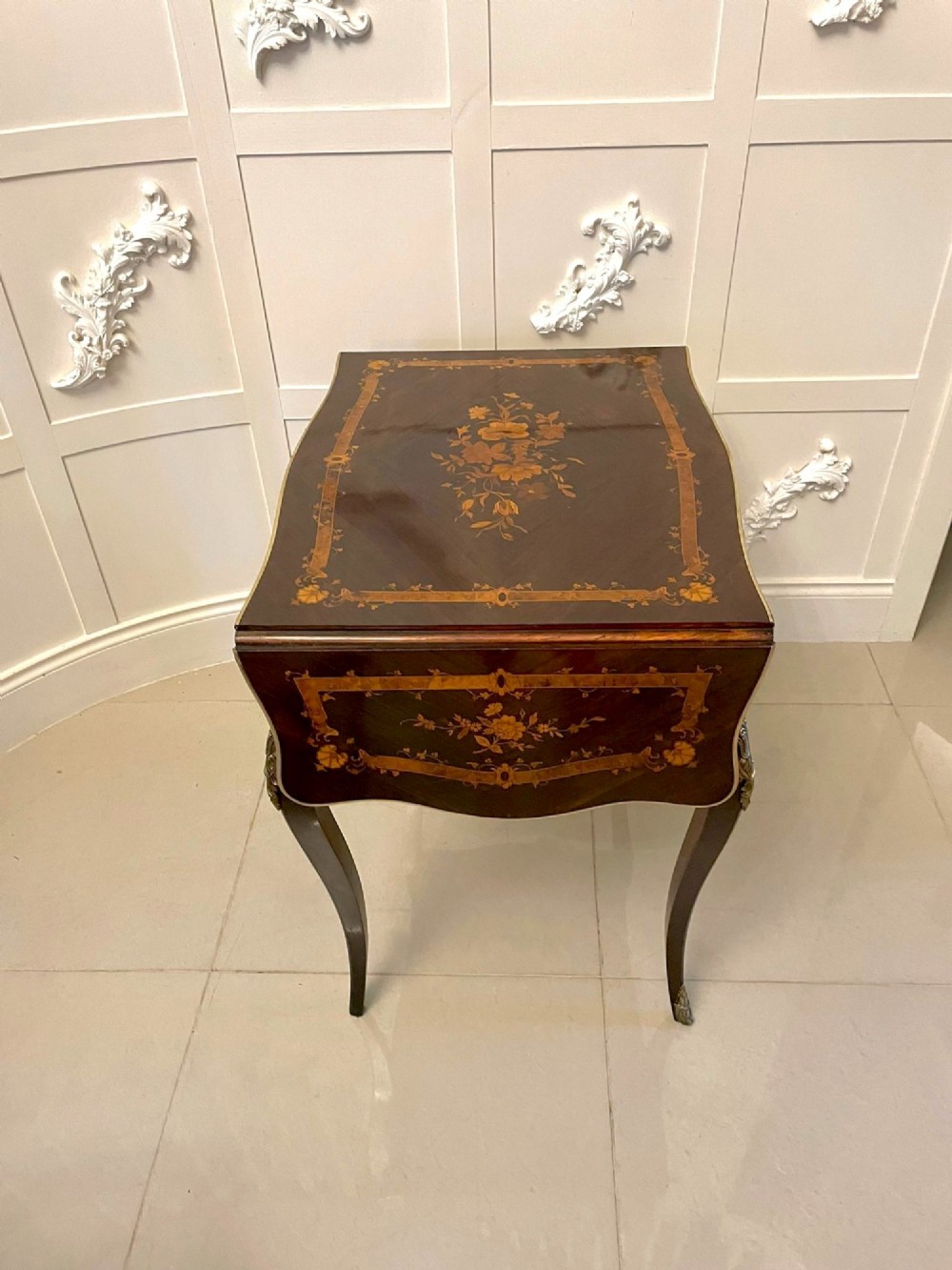 A French Louis XV style rosewood centre table featuring floral marquetry inlay, sweeping cabriole legs, and ornate gilt bronze mounts. View XII