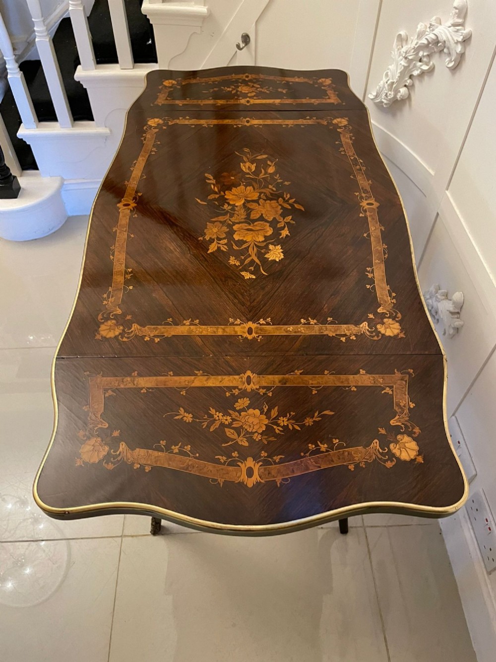 A French Louis XV style rosewood centre table featuring floral marquetry inlay, sweeping cabriole legs, and ornate gilt bronze mounts. View XIV