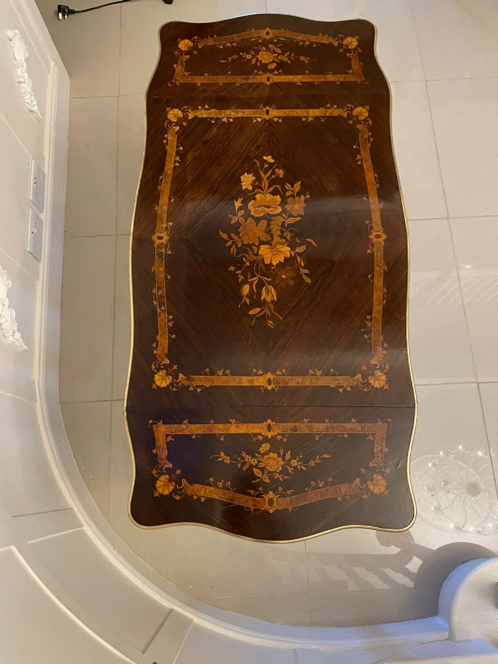 A French Louis XV style rosewood centre table featuring floral marquetry inlay, sweeping cabriole legs, and ornate gilt bronze mounts. View XV