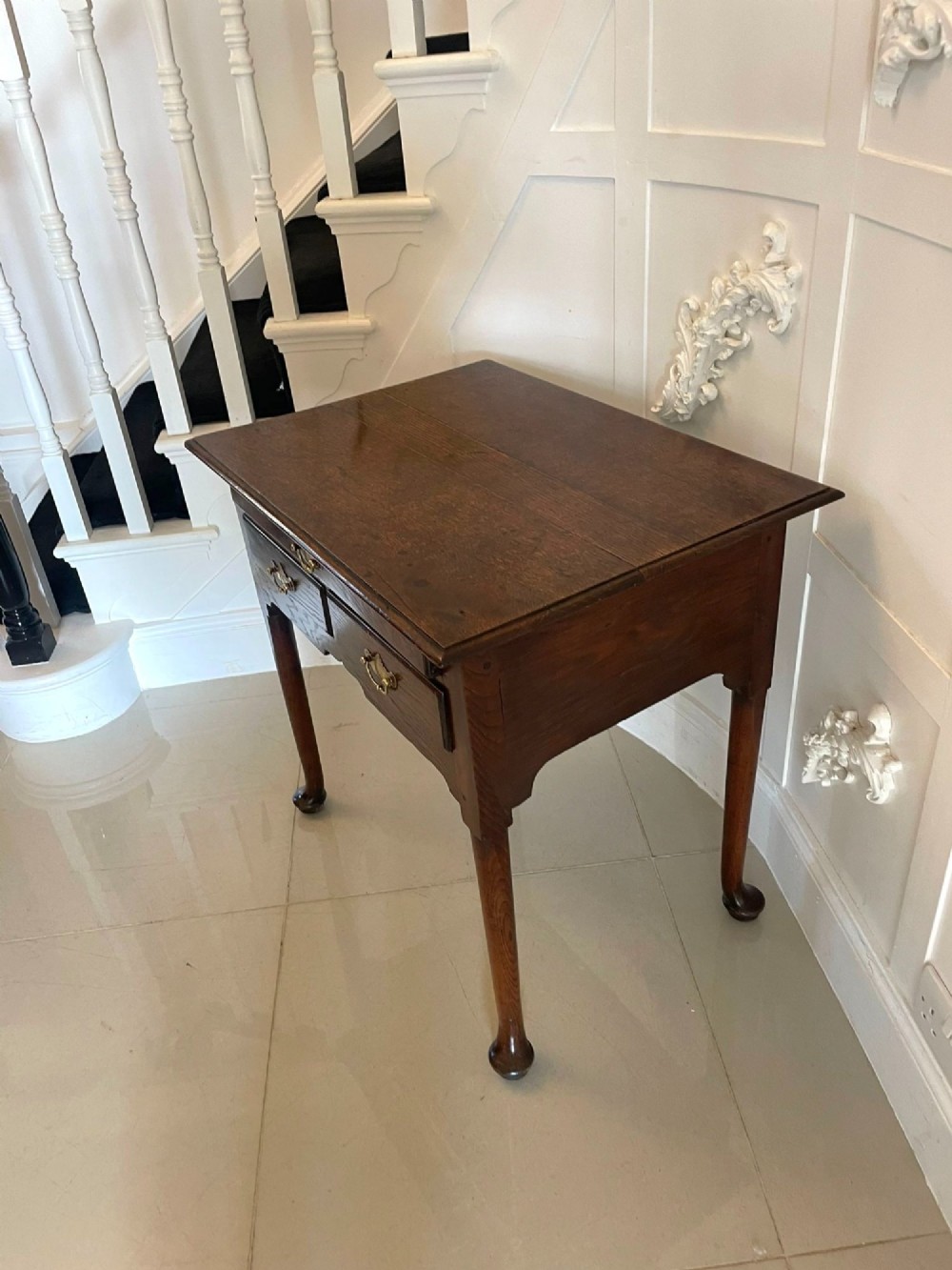 A George III oak lowboy table with three drawers, brass handles, a shaped apron, and cabriole legs with pad feet. View VII