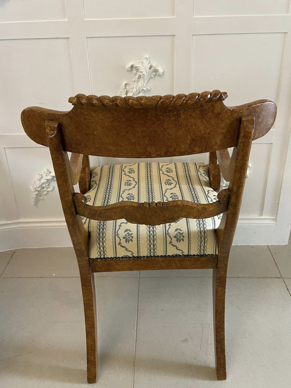 A set of eight antique Regency style dining chairs featuring decorative faux birds eye maple painted finishes and striped fabric seats. View V