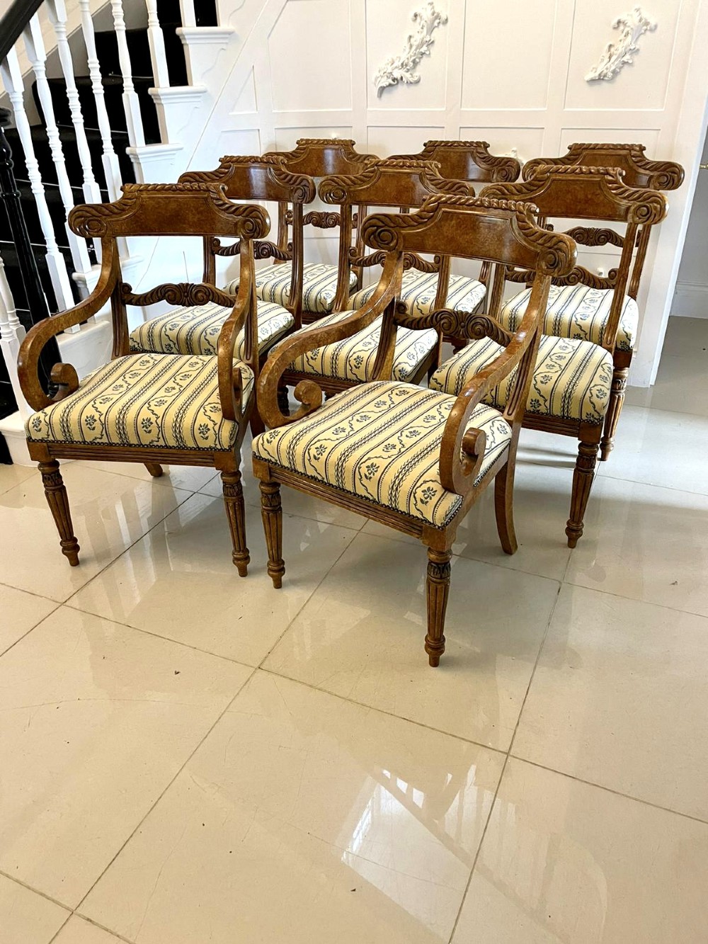 A set of eight antique Regency style dining chairs featuring decorative faux birds eye maple painted finishes and striped fabric seats. View XV