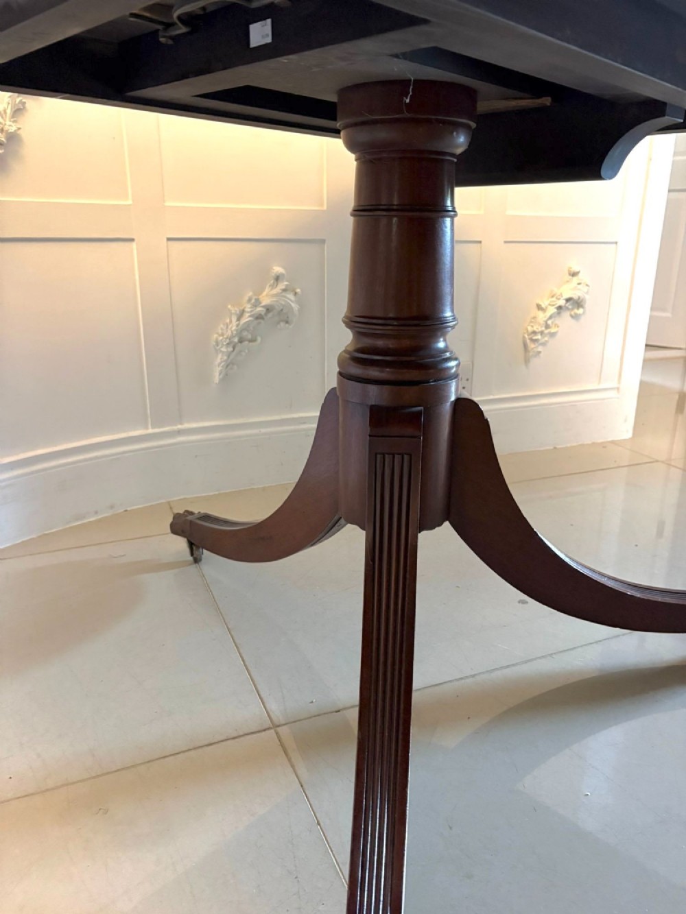 An exceptionally long mahogany banquet dining table supported on four turned pedestals with splayed legs and brass castors. View XIII