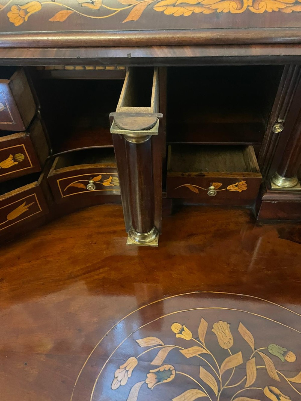 An 18th-century mahogany cylinder bureau decorated with detailed floral marquetry inlay across the curved roll-top and three lower drawers. View IV