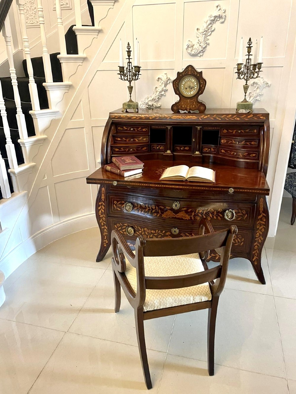 An 18th-century mahogany cylinder bureau decorated with detailed floral marquetry inlay across the curved roll-top and three lower drawers. View VII